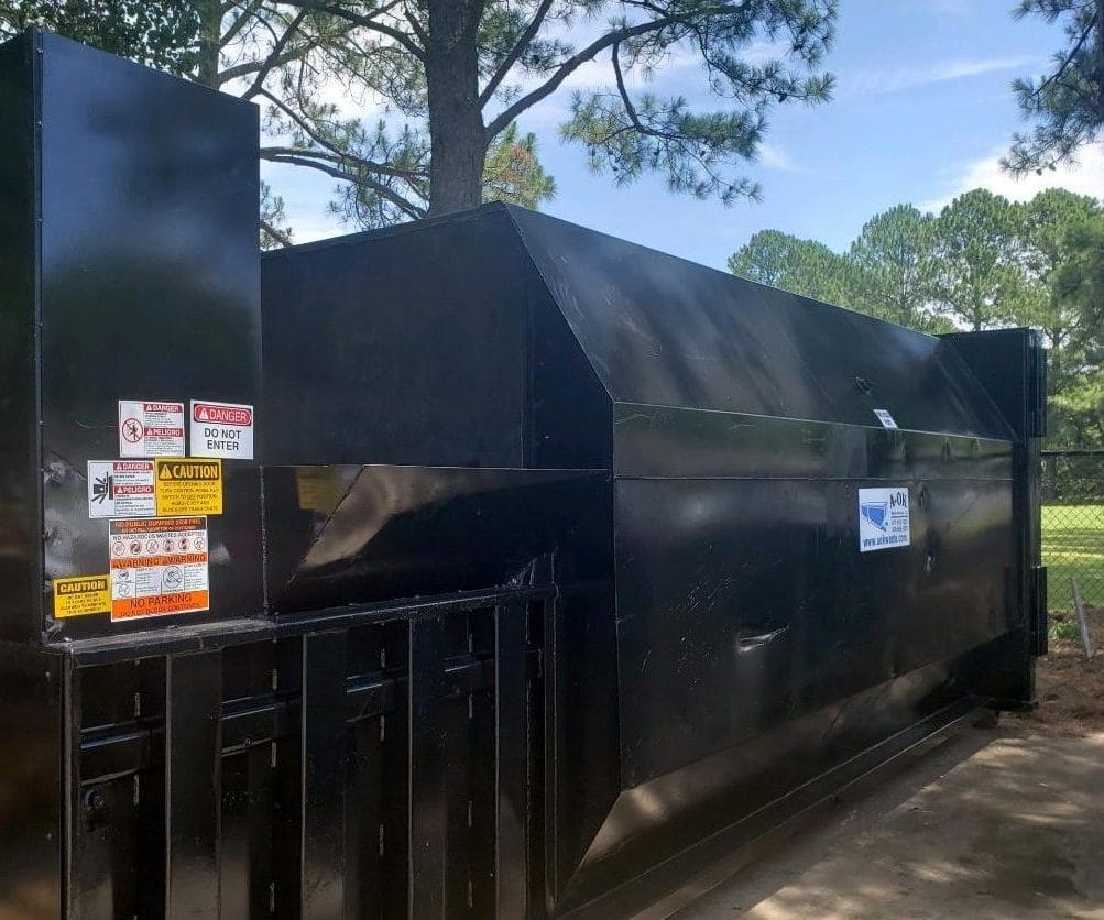 Black Trash Compactor Installed & Maintained Outside Building